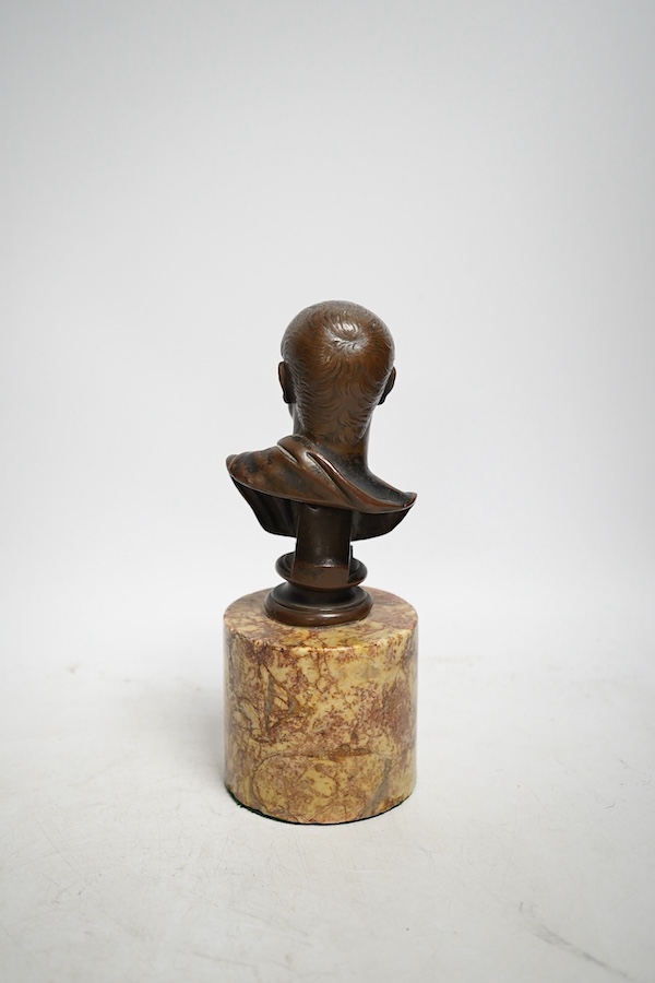 An early 20th century bronze bust of Menander on a marble stand, 19cm. Condition - some minor chips to marble otherwise good